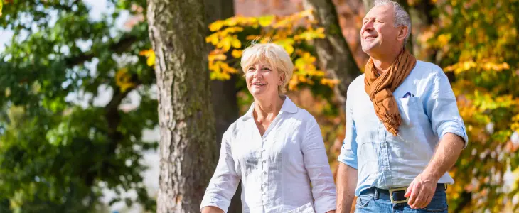 older couple strolling through a park